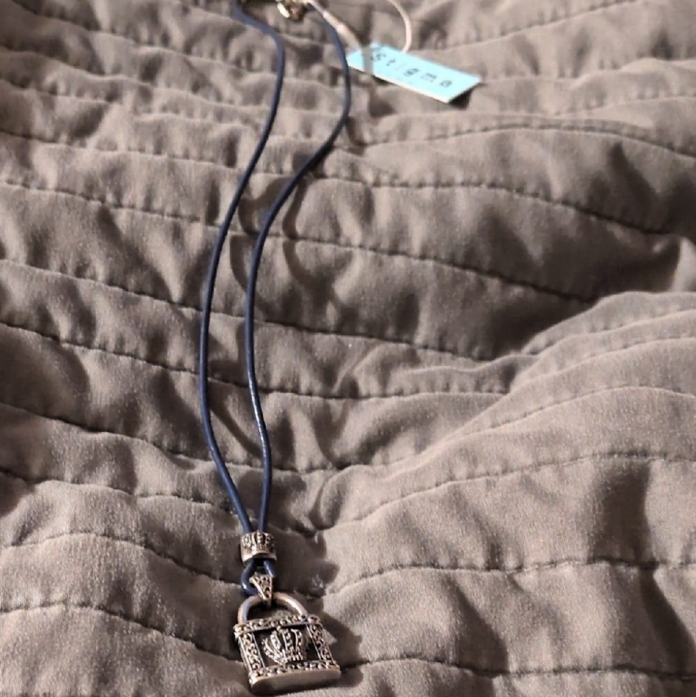 Intricate Silver Pendant Necklace with Blue Cord